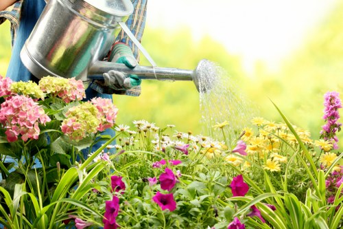 Worker wearing PPE while handling garden waste and tools